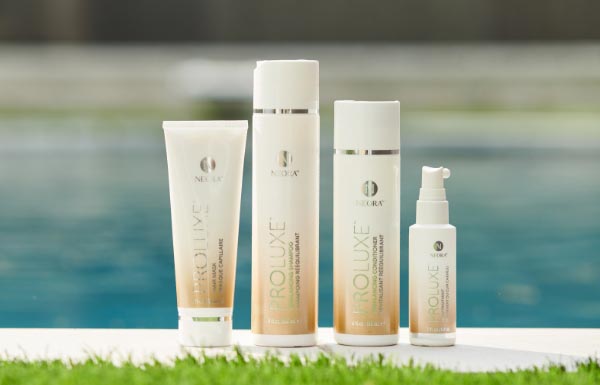 A lifestyle shot of the ProLuxe Hair Care System sitting outside in front of a swimming pool.
